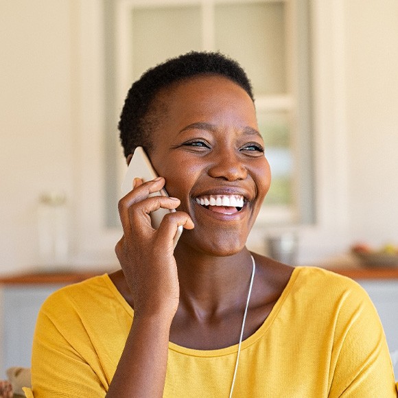 Woman smiling while talking on phone