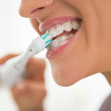 a close-up of a person brushing their teeth