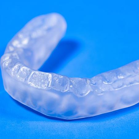 Custom mouthguard pictured against blue background
