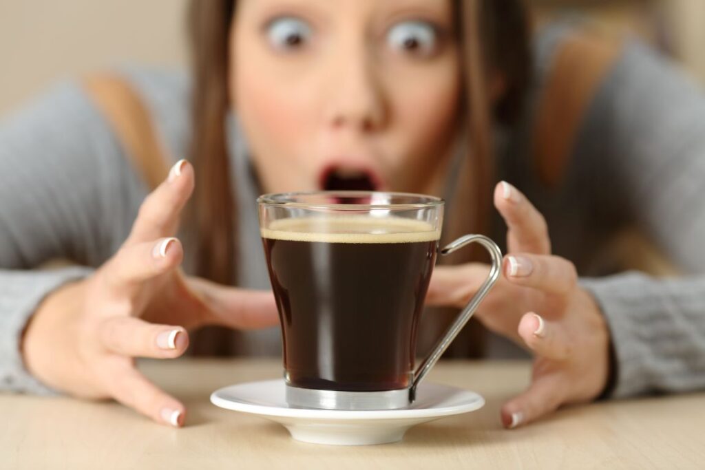 A woman looking at a cup of coffee