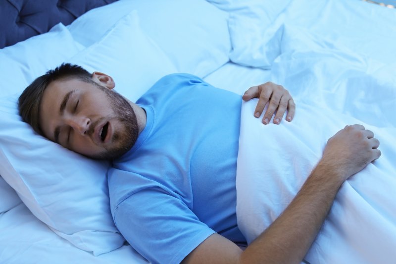 A young, sleeping man suffering from sleep apnea